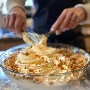 Layering cream mixture over crust in a glass dish for strawberry lasagna