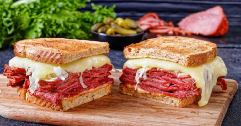 delicious Reuben sandwich with melted Swiss cheese, corned beef, and sauerkraut on toasted rye bread.